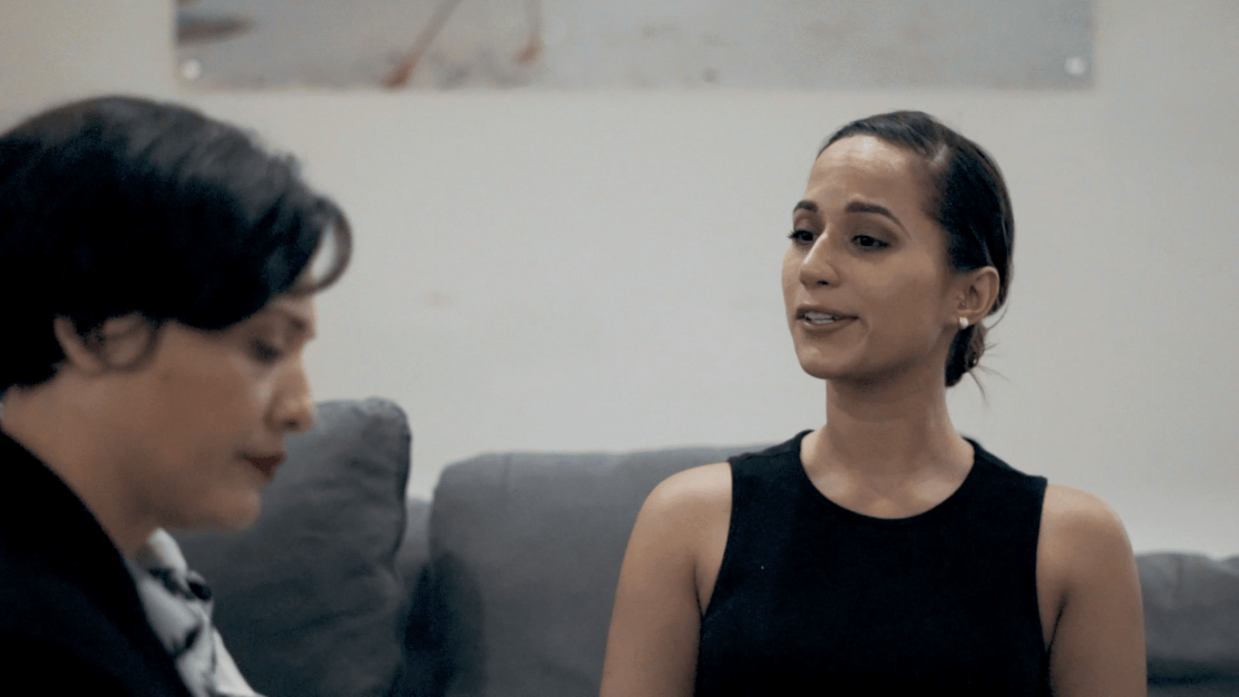 woman dressed in black top with low bun and stud eaarings-playing-with-fire-48hr-short-film-aruba-scene