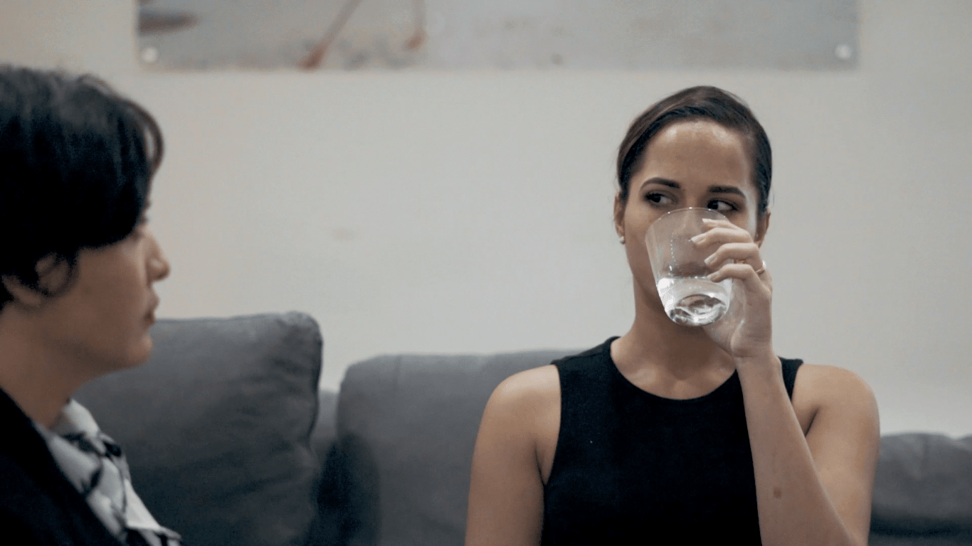 girl-drinking-water-out-of-glass-playing-with-fire-48hr-short-film-aruba-scene